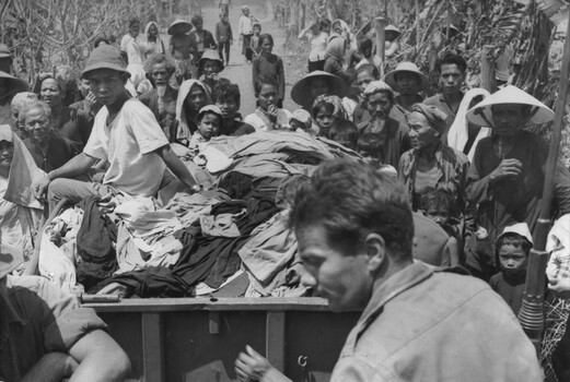 Diggers of 161 (Indep) Recce Flight prepare to distribute clean clothes, supplied by the 1st Australian Civil Arrairs Unit.