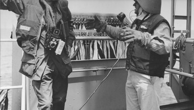 Lt Stanley L  Masterton briefs Australian War Correspondent, Denis Gibbons, during his visit to the Australian Guided Missile Destroyer HMAS Hobart.