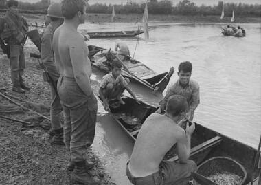 Trooper Normie Rowe views a number of Vietnamese fishing boats stopped in a "free fire zone".  