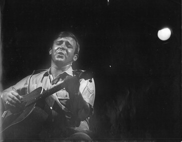 A black and white photograph of L/Cpl Normie Rowe representing Australia on Armed Forces TV. 