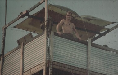 A Gunner of 104 Battery Royal Australian Artillery at Fire Base Betty, mans the observation tower constructed in the Fire Support Base. 