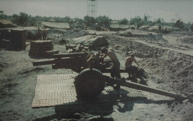 Gunners of 104 Battery Royal Australian Artillery at Fire Base Betty carry out maintenance on their gun durung a lull in fighting.  