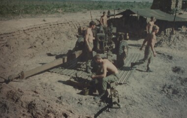 Gunners of 104 Battery, Royal Australian Artillery, at Fire Base Betty carry our maintenance on their gun durung a lull in fighting.  