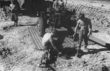 Gunners of 104 Battery Royal Australian Artillery at Fire Base Betty carry our maintenance on their gun durung a lull in fighting.  