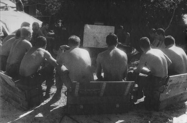 Gunners of 104 Battery Royal Australian Artillery at Fire Base Betty attend the nightly situation report and orders. 
