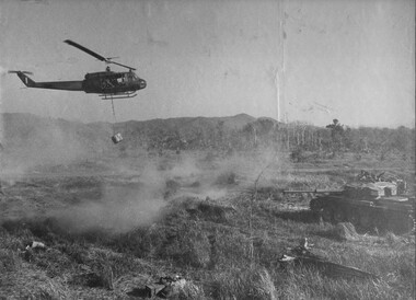 A Huey "Slick" helicopter from 9 Squadron,n RAAF delivers its re-supply to a Centurian Tank of 1st Armoured Regiment during Operation Matilda.