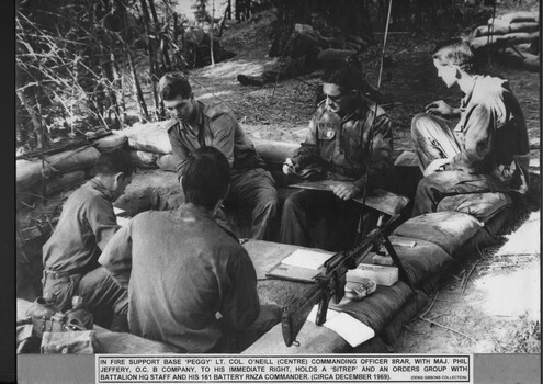 Five soldiers seated in Fire Support Base "Peggy".