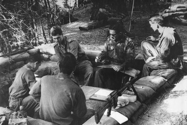Five soldiers seated in Fire Support Base "Peggy".