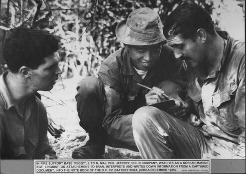 Three solders discussing vital information.