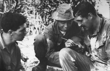 Three solders discussing vital information.