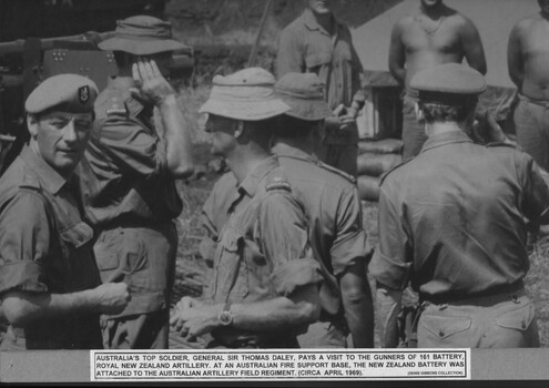 General Sir Thomas Daley visiting 161 Battery, Royal Newzealand Artillery at an Australian firebase. There are several soldiers in the photo.