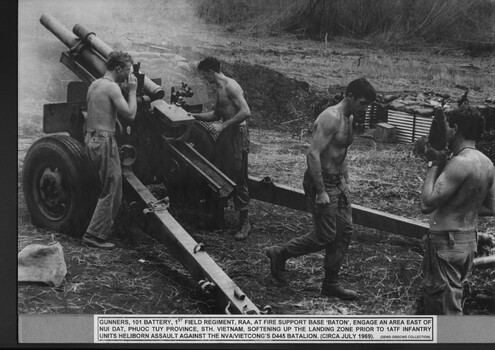 Four soldiers operating a howitzer