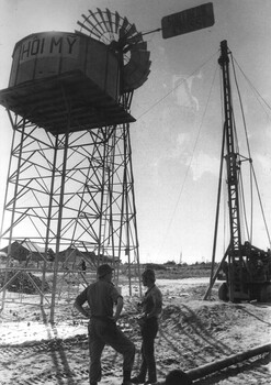 A photograph of the Hoi My Southern Cross Windmill water pump and the water pressure header tower.