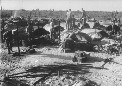 A photograph of Gunners at an Australian Fire Support Base building their sandbagged shelters against possible attack by NVA/VietCong. 