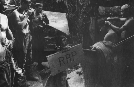 A photograph of a Fire Support Base Regimental Aid Post - here the Diggers enjoy a cold soft drink (goffer). 