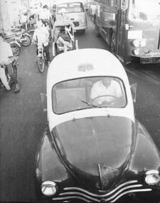 A photograph of a French Renault 8 taxi operating in Saigon. These little cars were the backbone of the Vietnamese taxi fleet. 