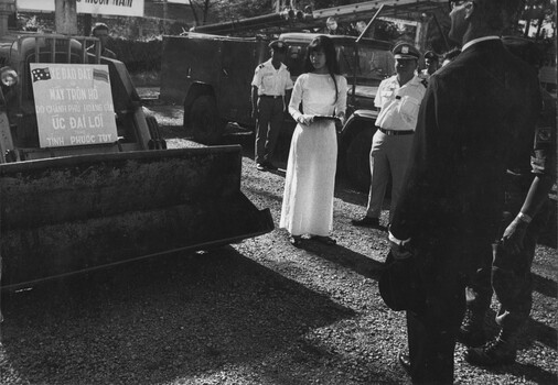 A photograph of the Australian Ambassador to South Vietnam, Mr Ralph Harry, inspecting a front-end loader at Phuoc Tuy Province Capital, Baria. 