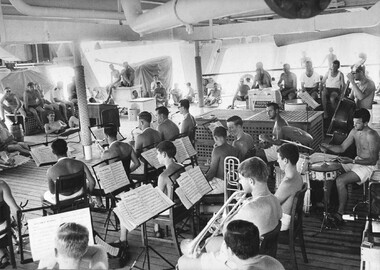 A photograph of the Vung Tau Ferry Band on board HMAS Sydney, performing a jazz concert for members of 9th Battalion, Royal Australian Regiment.