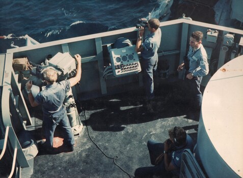 A photograph of crew members of HMAS Hobart (1967) searching the horizon during operations on the gun line, Tonkin Gulf. 