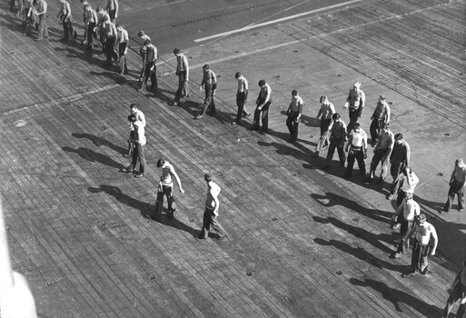 A photograph of crew members of Vung Tau Ferry going through the ritual of walking the deck prior to a Sea King helicopter launch. 