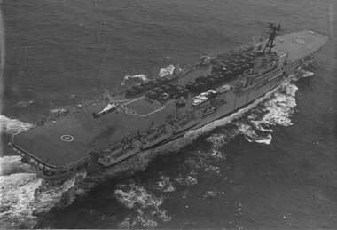 A photograph of the fully laden Vung Tau Ferry" HMAS Sydney containing 9RAR vehicles and equipment, making way towards Vung Tau. 