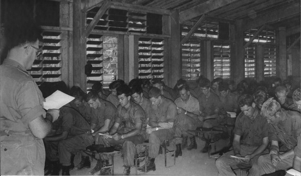 A photograph of the congregation of diggers, following lesson by the Church of England Padre at the combined service in the non-denominational chapel. 