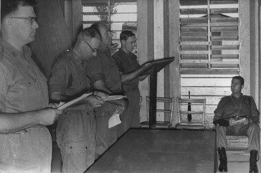 A photograph of four denominations of 1st Australian Task Force Padres conducting a combined service at the non-denominational chapel. 