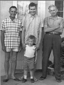 A photograph of the Gibbons family, left to right: Stanley William Gibbons, Denis Stanley Gibbons, in front Peter Denis Gibbons, and Robert William Gibbons. 