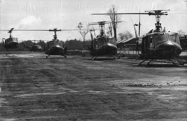 A photograph of Huey Helicopters from the 135th Assault Helicopter Company landing at the edge of an airfield located in the Mekong Delta. 