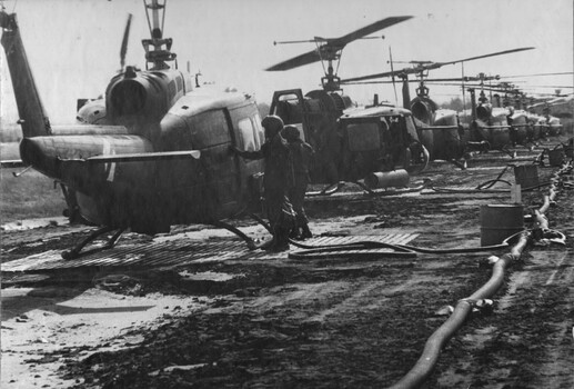 A photograph of crew members from the 135th Assault Helicopter Company refuelling their aircraft, as they wait for a new tasking. 