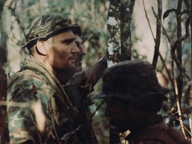 A photograph of two members from the Australina Army Training Team Vietnam (AATTV) operating with a Montagnard Mike Force Battalion. 