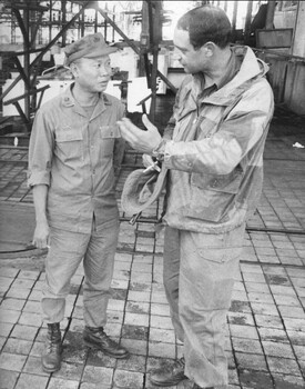 A photograph of Lt Col Khan CO 5 RAR as he advises the Duc Thanh District Chief Maj Tram Van Ngo on the VietCong bodies.