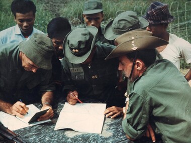 A photograph of two members of the AATTV operating with the Army Of The Republic Of Vietnam (ARVN).