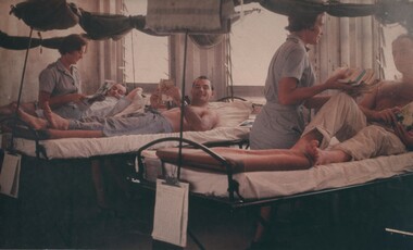 A photograph of 8 Field Ambulance Hospital Red Cross nurses, Janice Webb and Jean Debelle, doing the rounds with the wounded and sick Diggers.