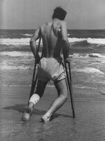 A photograph of Pte Dave Henderson, a wounded scout from 8 RAR,  as he contemplates the rolling surf at the Back Beach. 