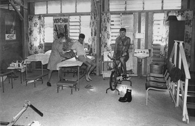 A photograph of Physiotherapist, Lt Sue Wooley with Pte John Casey in the 1st Australian Field Hospital, Vung Tau, South Vietnam. 