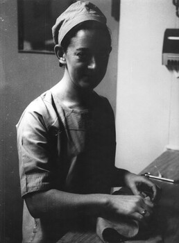 A photograph of Sister Fay Lewis preparing Operating Theatre instruments for sterilization in an autoclave at the 1st Australian Field Hospital.