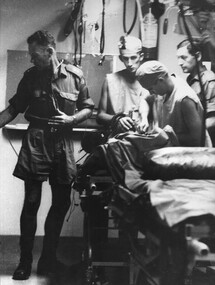 Lt Col Ian Miller, Medic Peter Carey, Surgeon Ed Carr, and Medic John Tullohin in triage at the 1st Australian Field Hospital. 