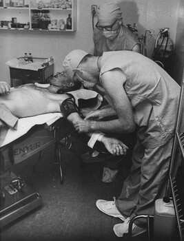 A photograph of Corporal Alex (Chuck) Berry and the anaesthetist in the operating theatre at the 1st Australian Field Hospital, Vung Tau. 