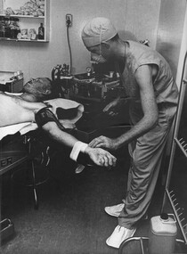 A photograph of Corporal Alex (Chuck) Berry in the operating theatre at the 1st Australian Field Hospital, Vung Tau.