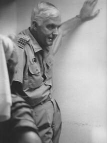 A photograph of CDr Alan Beech watches along with the hospital Matron Maj Nell Espie, as a triage team resusitates a wounded Digger. 