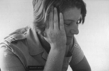 A photograph of Red Cross member Rosemary Griggs catching  cat nap after a vigorous day on duty in the Red Cross hut and hospital wards.