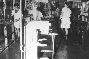 A photograph of cooks, and female civilian Vietnamese kitchen staff person, preparing an evening at the 1st Australian Field Hospital, Vung Tau.