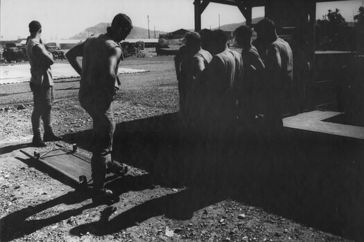 A photograph of 1st Australian Field Hospital Medics, Tony Green and Ron Gillespie and their team, awaiting an incoming Dustoff medivac. 