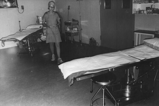 A photograph of  Sister Captain June Minchow, at 1st Australian Field Hospital after checking stores and equipment required for the operating theatre. 