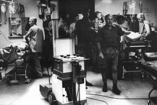 A photograph taken triage in the 1st Australian Field Hospital. Surgeons, anaesthetists, medics, radiographer and x-ray technicians are all on handto treat incoming Diggers 