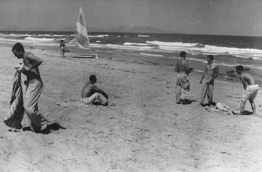 A photograph of Diggers from the 1st Australian Field Hospital, Vung Tau, enjoying some time in the sun and launch a sail driven surfboard. 