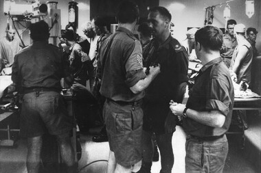 A photo at 1st Australian Field Hospital, In the left bay, a female VietCong prisoner is x-rayed and a male VietCong prisoner is assessed. 