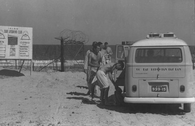 A photograph of ambulatory patients at the Back Beach from the 1st Australian Field Hospital, loaded into the Red Cross combi van. 