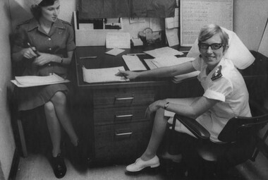 A photograph of ANZAC Nursing Sisters Lt Patricia Ferguson (RAANC) receives a hand-over report from Capt Clare Jacobson (RNZANC). 